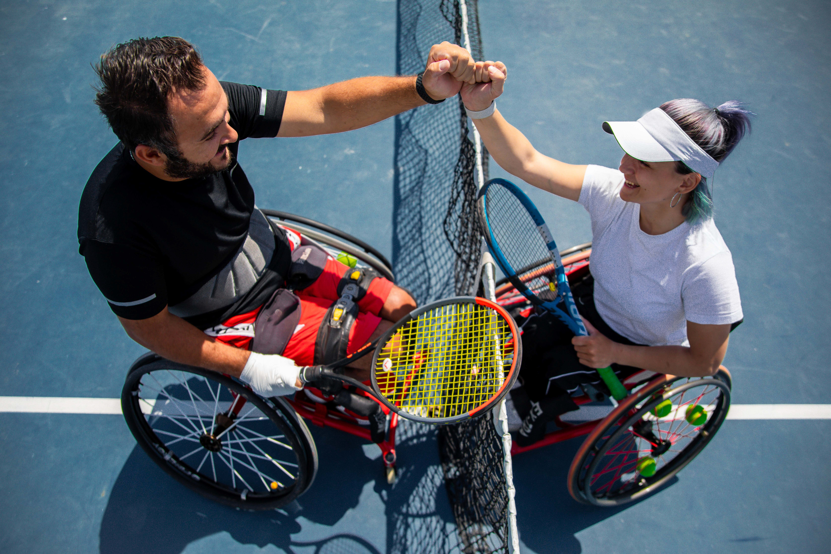 Persons with Disabilities Doing Fist Bump After Tennis Match